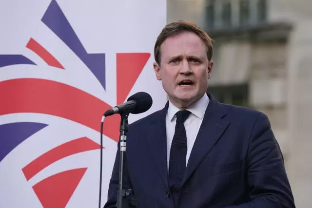 Tom Tugendhat speaking in front of a microphone