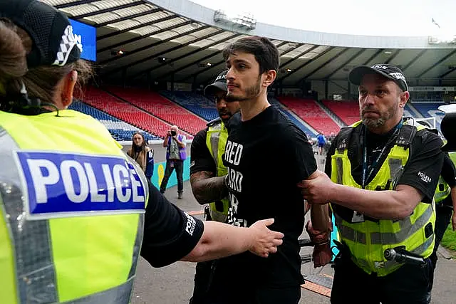 The protester is escorted away by police 