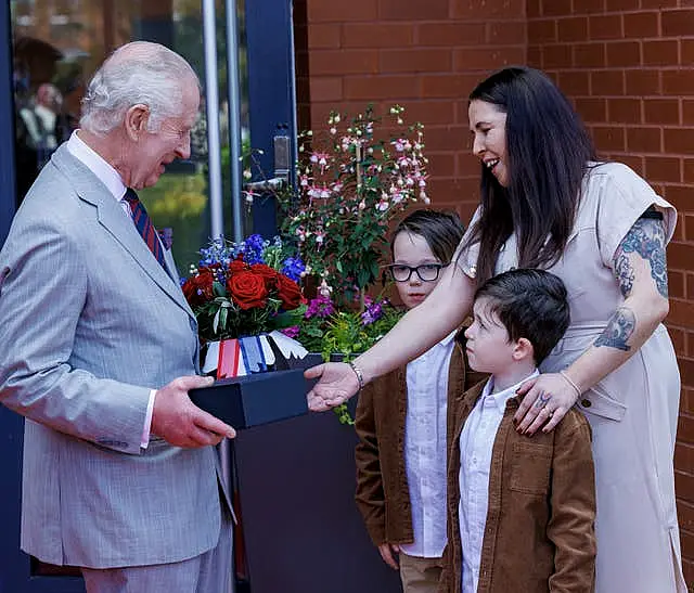 Charles receives gifts of flowers and Royal Engineer china mugs