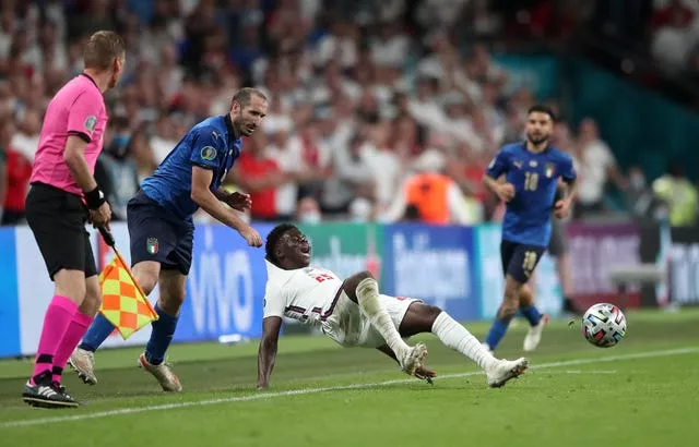 Italy’s Giorgio Chiellini (left) pulls back England’s Bukayo Saka during the Euro 2020 final 