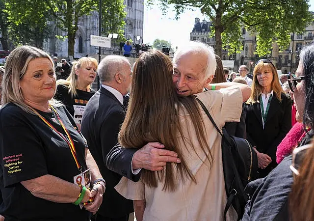 Chairman of the infected blood inquiry Sir Brian Langstaff with victims and campaigners 