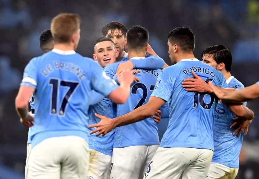 Manchester City players gather to celebrate Phil Foden's goal against Brighton on Wednesday evening