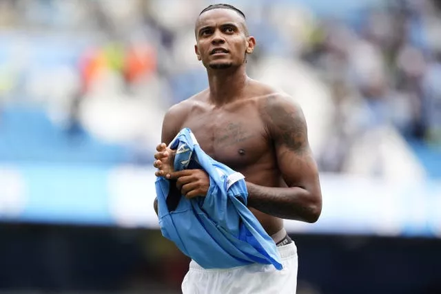 Manchester City defender Manuel Akanji takes his shirt off after Saturday's victory over Brentford