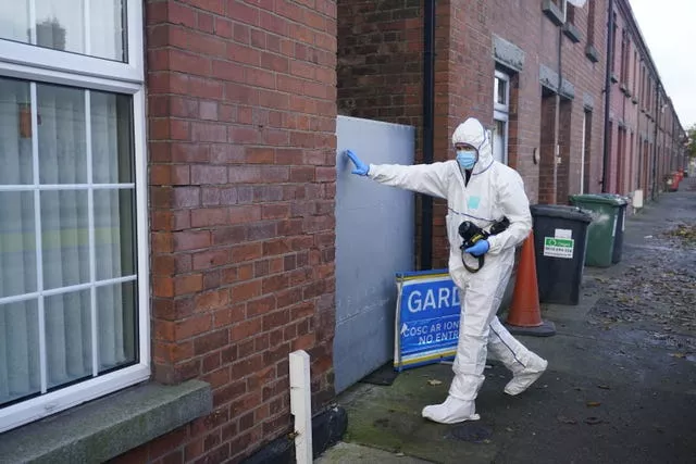 A forensic officer entering a house