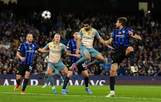 Manchester City’s Ilkay Gundogan, centre right, heads at goal against Inter Milan