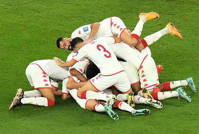 Tunisia celebrate after Wahbi Khazri (hidden) gave them the lead against defending world champions France
