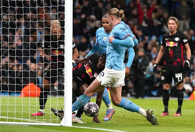 Erling Haaland bundles home his and Manchester City’s third goal