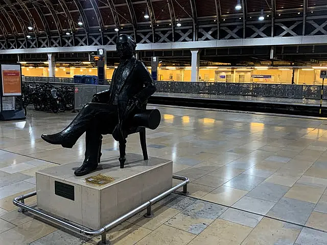 A statue of Isambard Kingdom Brunel sits on an empty platform at Paddington railway station (Peter Clifton/PA)