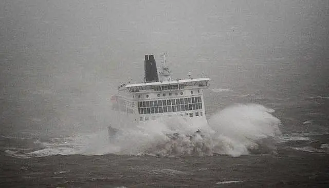 A DFDS ferry arrives in stormy conditions at the Port of Dover in Kent 