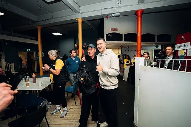 Diogo Dalot, right, visiting Manchester’s oldest homeless charity