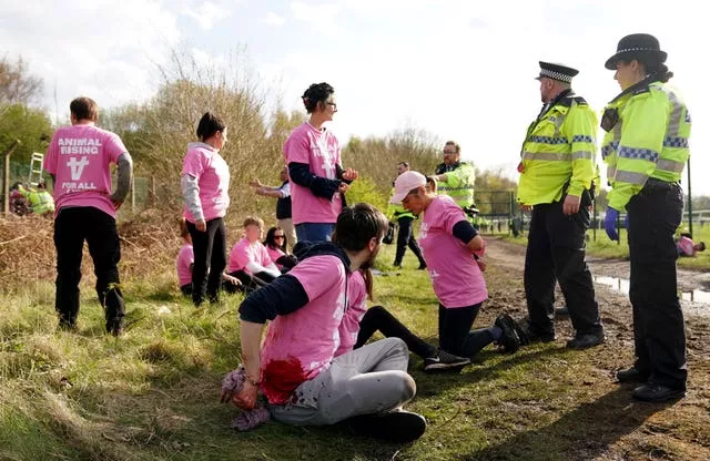 Protesters are detained by police at Aintree