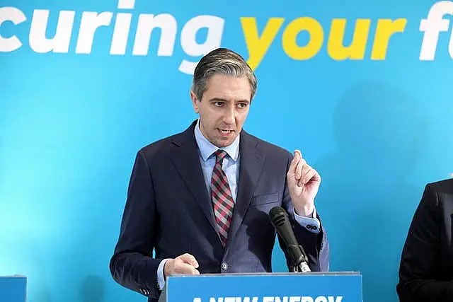 Simon Harris gestures while speaking