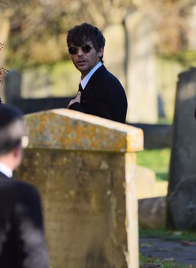 Former One Direction band member Louis Tomlinson arrives for the funeral service of One Direction singer Liam Payne 