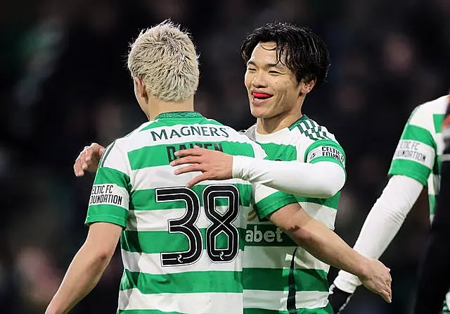 Reo Hatate and Daizen Maeda celebrate Celtic's second goal at Dundee United (Steve Welsh/PA)