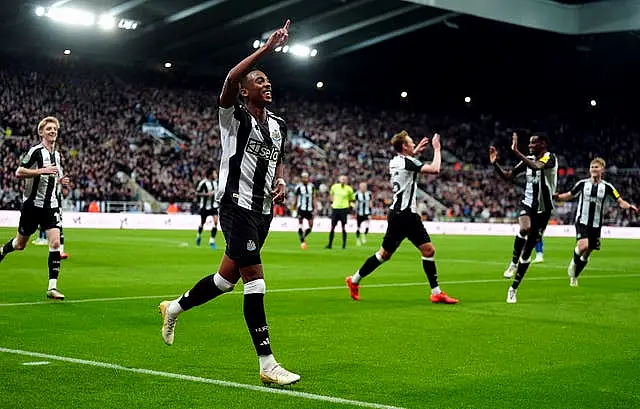 Joe Willock puts his right arm in the air to celebrate Newcastle's second goal