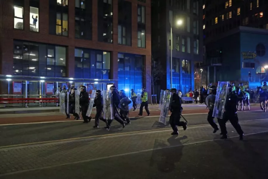 Riot police, with police horses behind them, move down Rupert Street in Bristol 