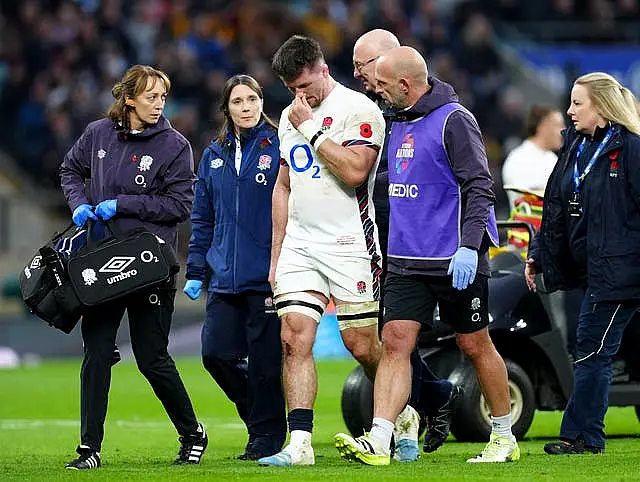 Tom Curry, centre, is led off the field by medical staff after suffering a concussion against Australia