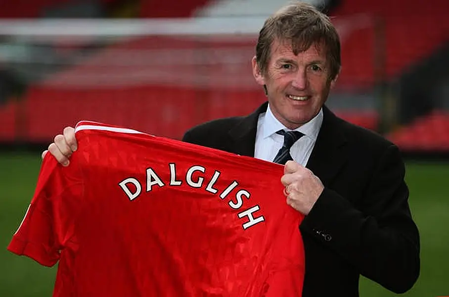 Kenny Dalglish holds up a Liverpool shirt