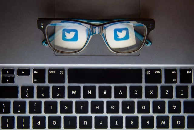 The logo of social network site Twitter reflected in a pair of glasses