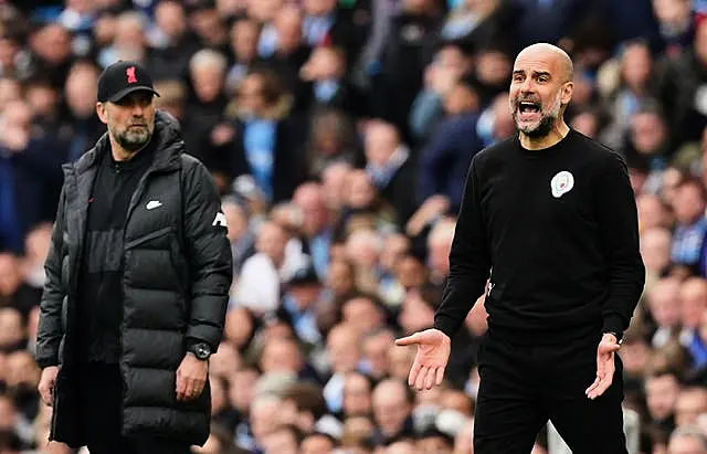 Manchester City manager Pep Guardiola (right) and Liverpool boss Jurgen Klopp on the touchline