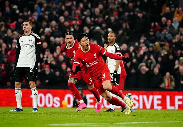 Liverpool's Wataru Endo (centre) celebrates scoring his sides third goal