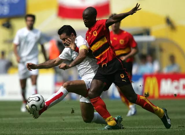Ali Daei battles for the ball with Joao Jamba of Angola in 2006