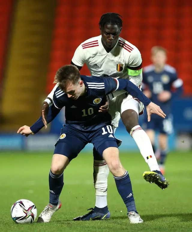 Belgium midfielder Amadou Onana tackles Scotland's Marc Leonard
