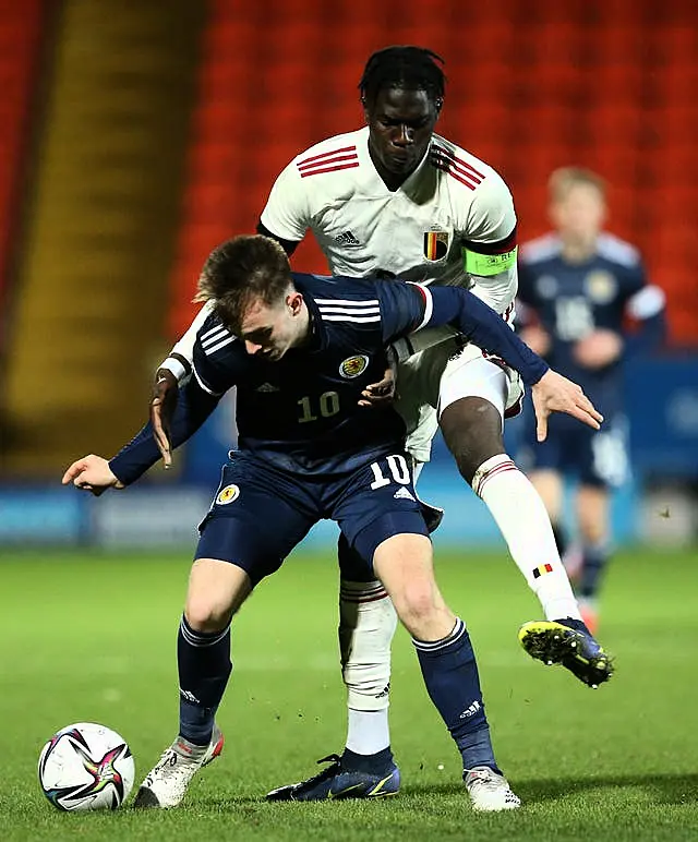 Belgium midfielder Amadou Onana tackles Scotland's Marc Leonard