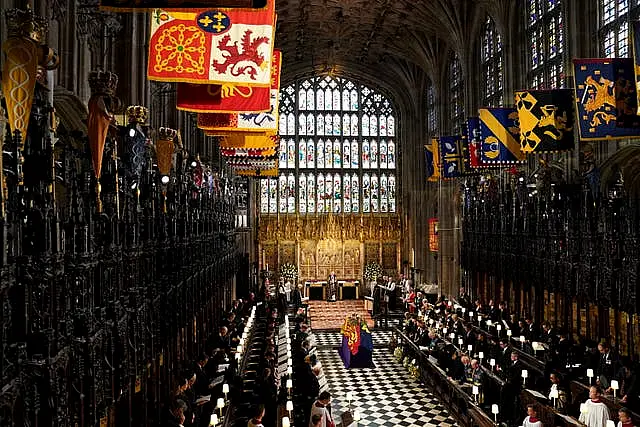 The coffin of Queen Elizabeth II, draped in the Royal Standard at St George's Chapel (Joe Giddens/PA)