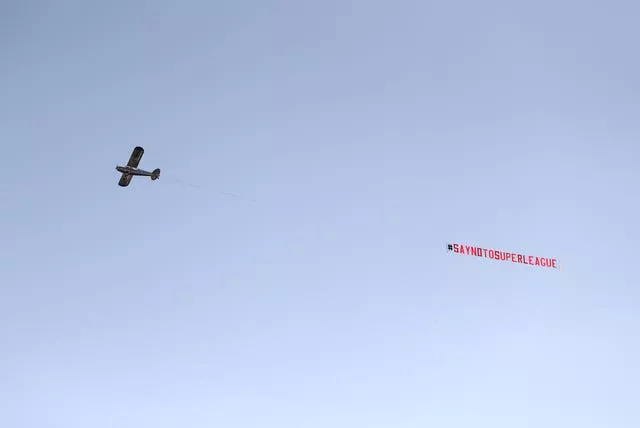 A plane carries a banner protesting against the European Super League