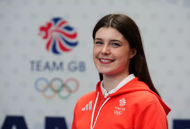 Andrea Spendolini-Sirieix in a profile picture, smiling and wearing Team GB kit in front of a wall featuring the team logo