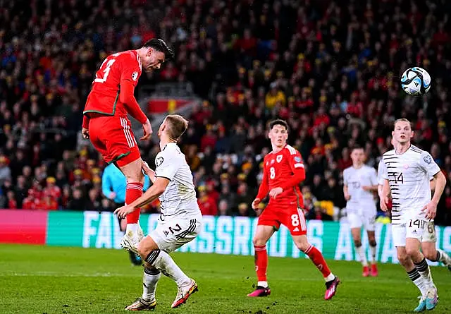 Kieffer Moore, left, heads Wales in front against Latvia