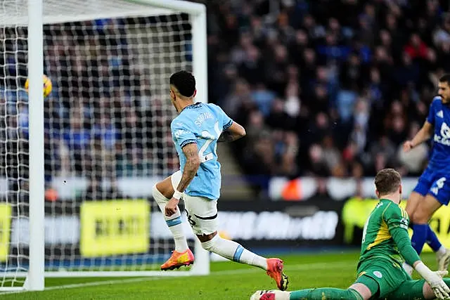 Manchester City’s Savinho has got past Leicester goalkeeper Jakub Stolarczyk and hits the ball into the top of the net to score