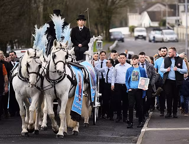The horse-drawn carriage carrying the coffin of John Keenan