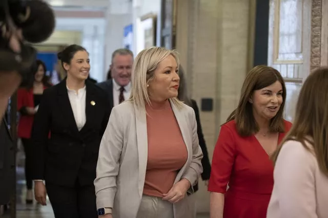 Sinn Fein's Michelle O’Neill leaves the Northern Ireland Assembly chamber with the SDLP’s Sinead McLaughlin 