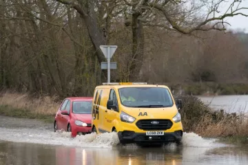 A car is towed through floodwater
