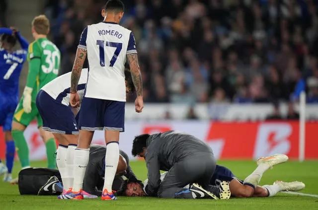 Tottenham’s Rodrigo Bentancur lies on the ground receiving treatment after a head injury against Leicester