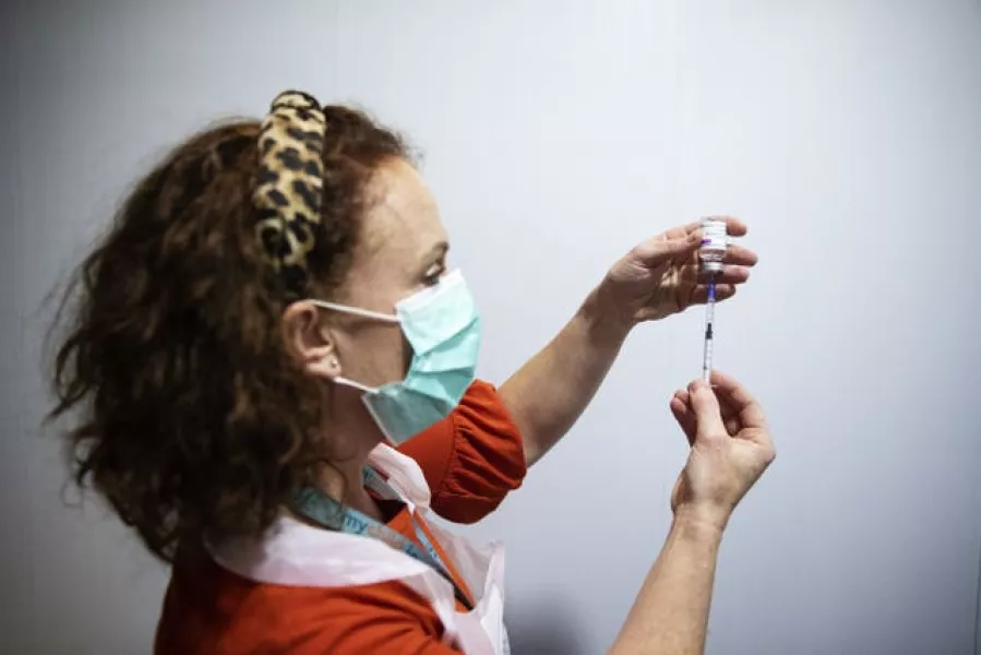 Public Health Nurse Deirdre Murphy with a vial of the AstraZeneca Covid-19 vaccination at the mass vaccination centre in the Helix, DCU, Dublin (Brian Lawless/PA)