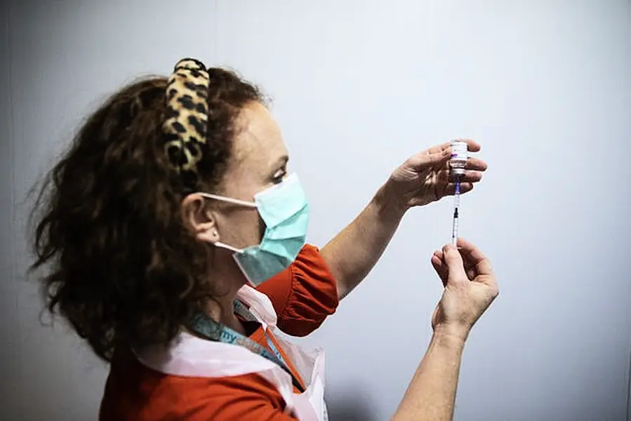 Public Health Nurse Deirdre Murphy with a vial of the AstraZeneca Covid-19 vaccination at the mass vaccination centre in the Helix, DCU, Dublin (Brian Lawless/PA)