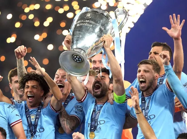 Captain Ilkay Gundogan, centre, lifts the trophy as Manchester City celebrate Champions League success