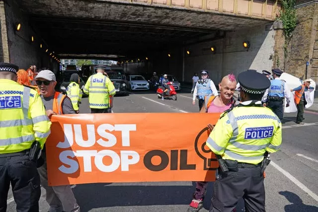 Just Stop Oil activists take part in slow walk protest in Vauxhall, central London