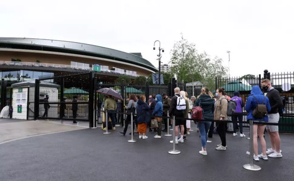 Tennis fans queue to enter the grounds on day eight of Wimbledon