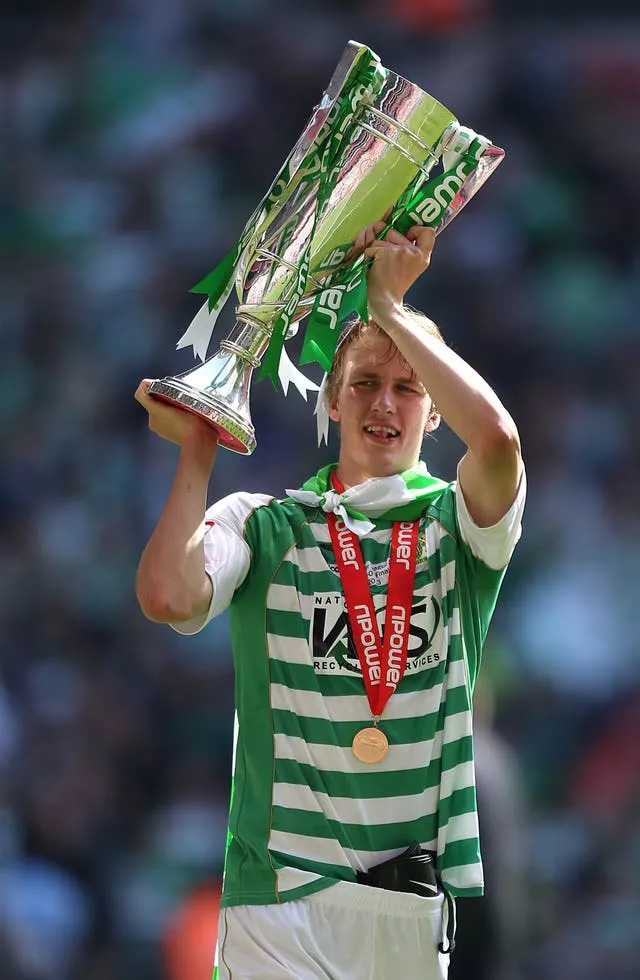 Yeovil’s Dan Burn celebrates with the League One play-off final trophy