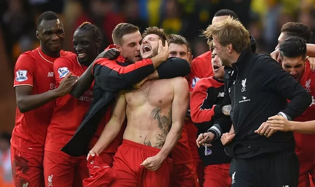 Liverpool’s Adam Lallana (centre) celebrates with his team-mates after netting a late winner