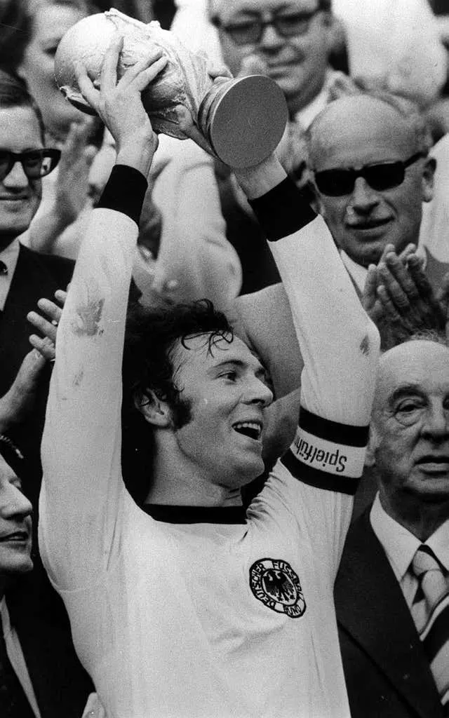 Franz Beckenbauer lifts the World Cup trophy as Germany captain in 1974