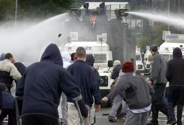 Police using a water cannon to disperse nationalists