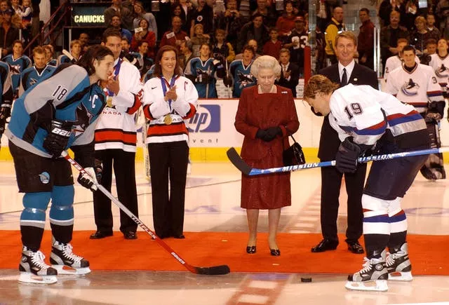 Queen Elizabeth II starts an ice hockey game between San Jose Sharks and Vancouver Canucks during her two-week Golden Jubilee tour of Canada