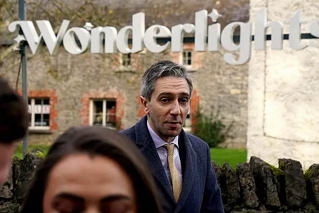 Taoiseach Simon Harris underneath a sign saying Wonderlight