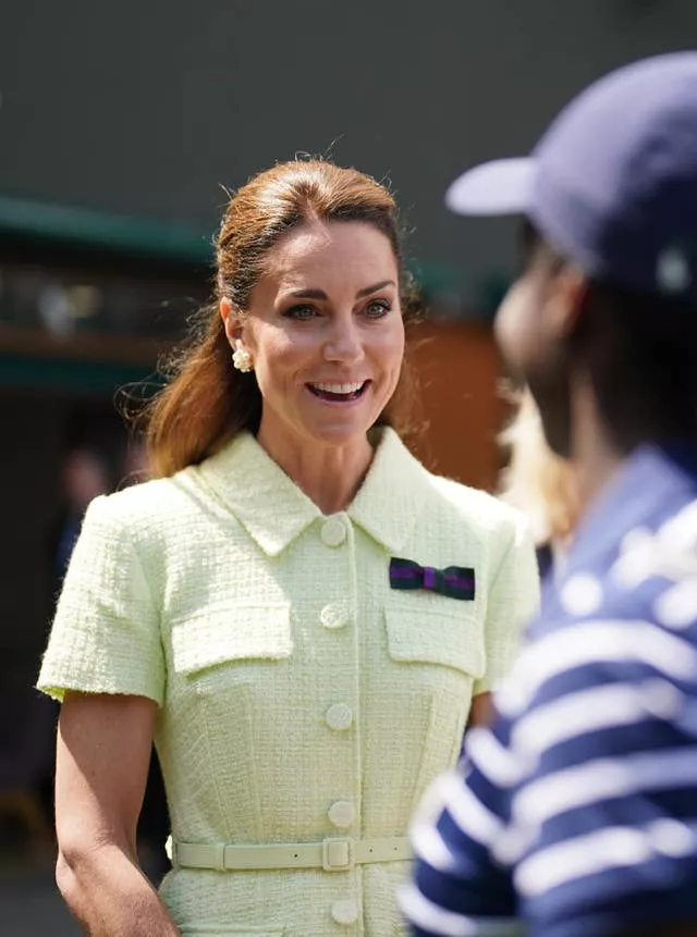 The Princess of Wales speaks to ball boys and girls on day thirteen of the 2023 Wimbledon Championships at the All England Lawn Tennis and Croquet Club in Wimbledon