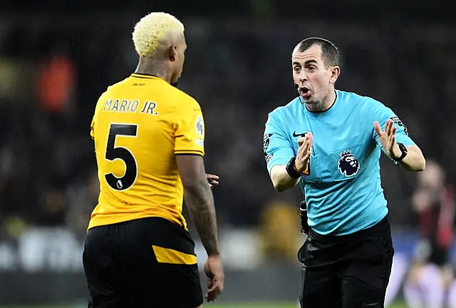 Referee Peter Bankes, right, speaks to Wolves’ Mario Lemina